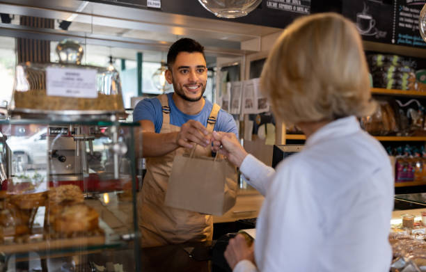 A store team member handing over a Surprise Bag at collection